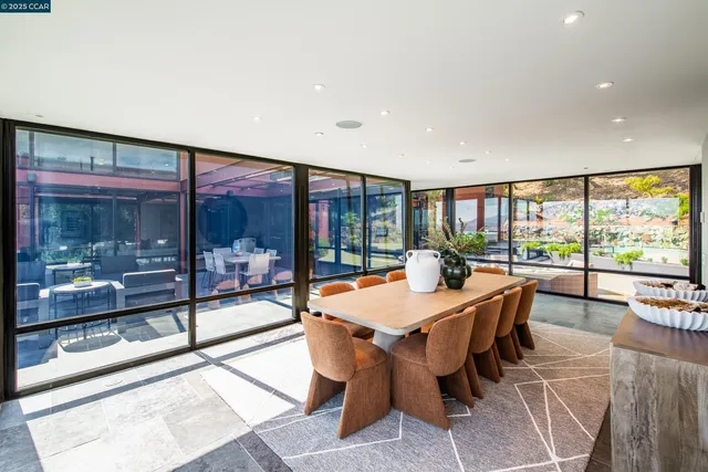 a dining room with furniture a chandelier and wooden floor