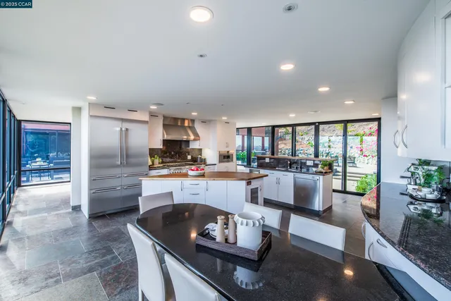 a living room with furniture floor to ceiling window and a flat screen tv