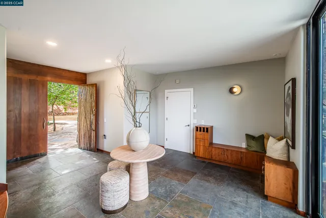 a view of a livingroom with furniture wooden floor and staircase