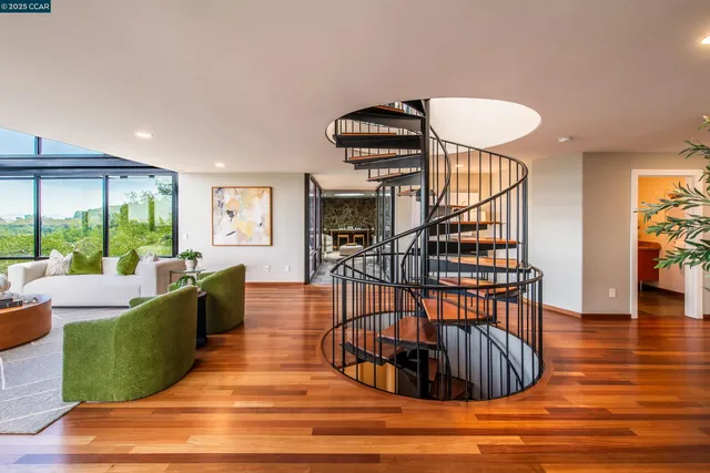 a living room with furniture a rug and a wooden floor