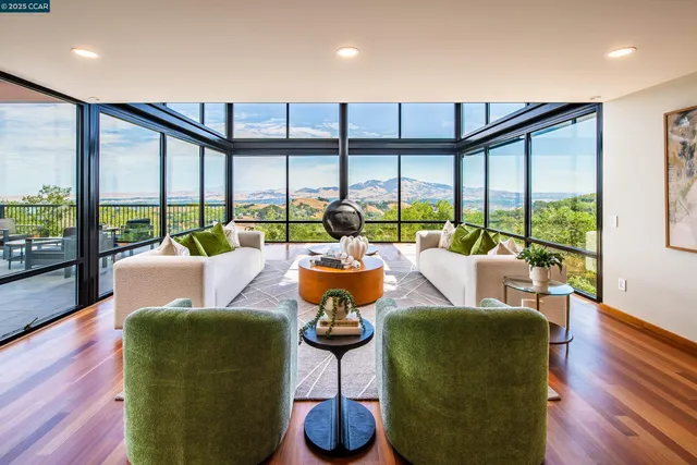 a living room with furniture and a floor to ceiling window