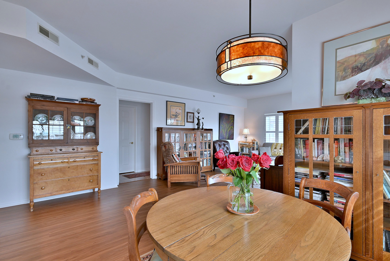210 North Addison Avenue, Unit 301 Elmhurst, IL 60126 - Photo 12 of 30 a view of a dining room with furniture a potted plant and wooden floor