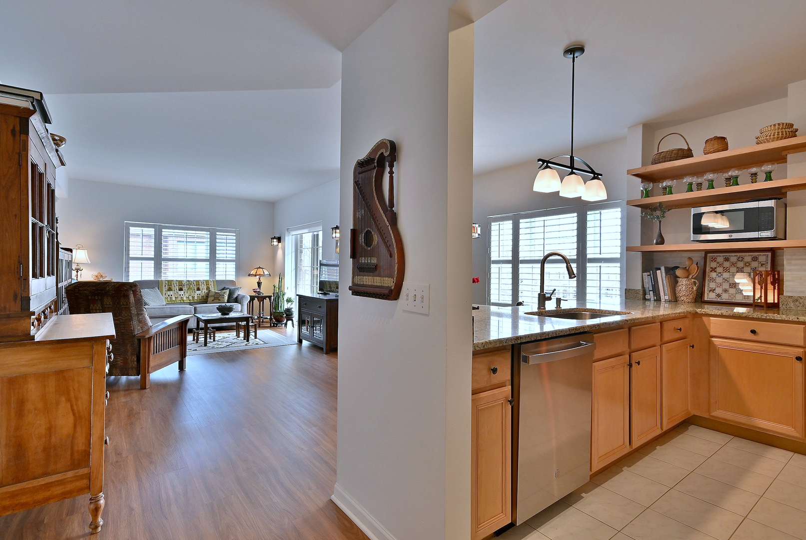 210 North Addison Avenue, Unit 301 Elmhurst, IL 60126 - Photo 15 of 30 a open kitchen with stainless steel appliances granite countertop a stove top oven a refrigerator a dining table and chairs with wooden floor
