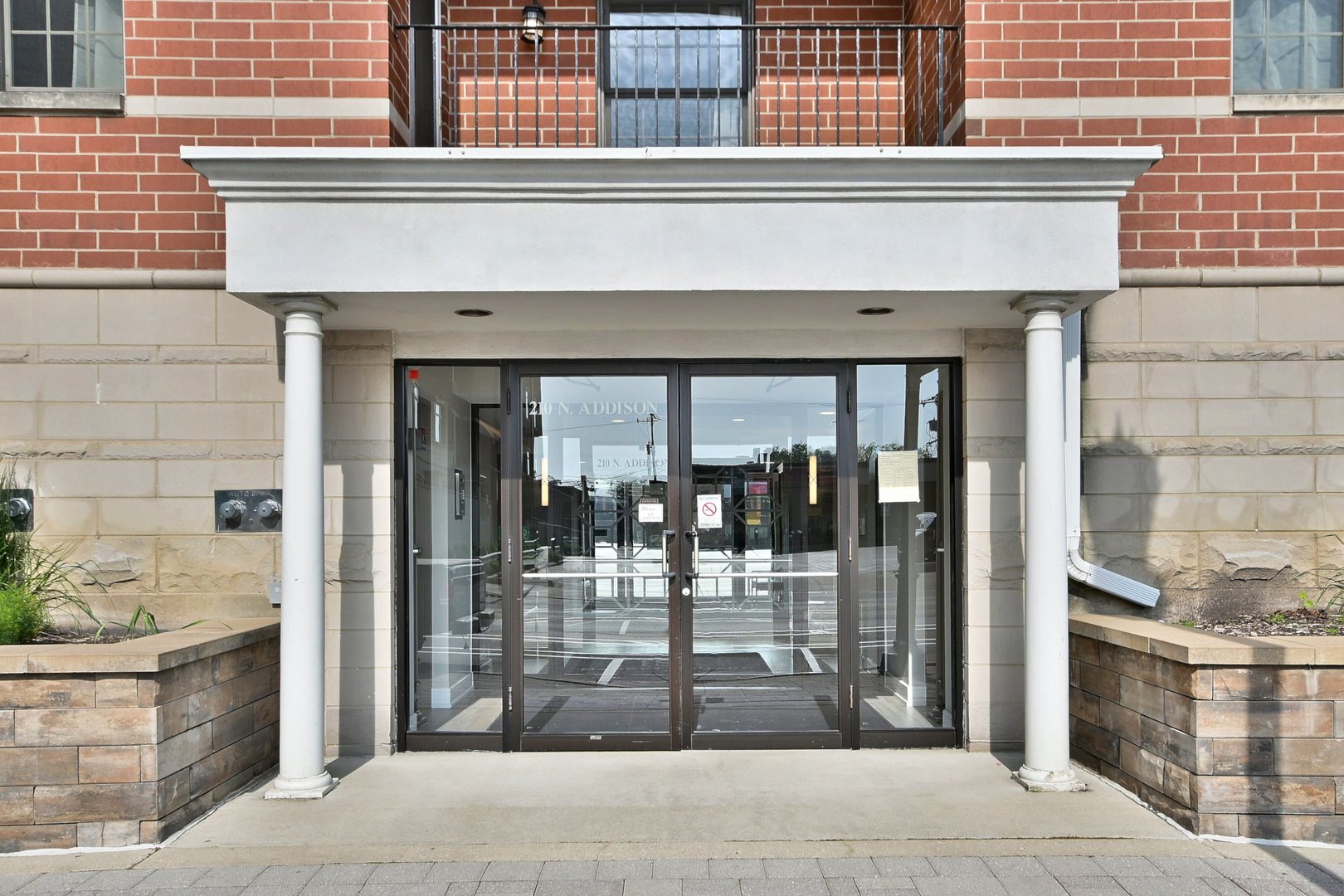 210 North Addison Avenue, Unit 301 Elmhurst, IL 60126 - Photo 4 of 30 a front view of a building with glass door