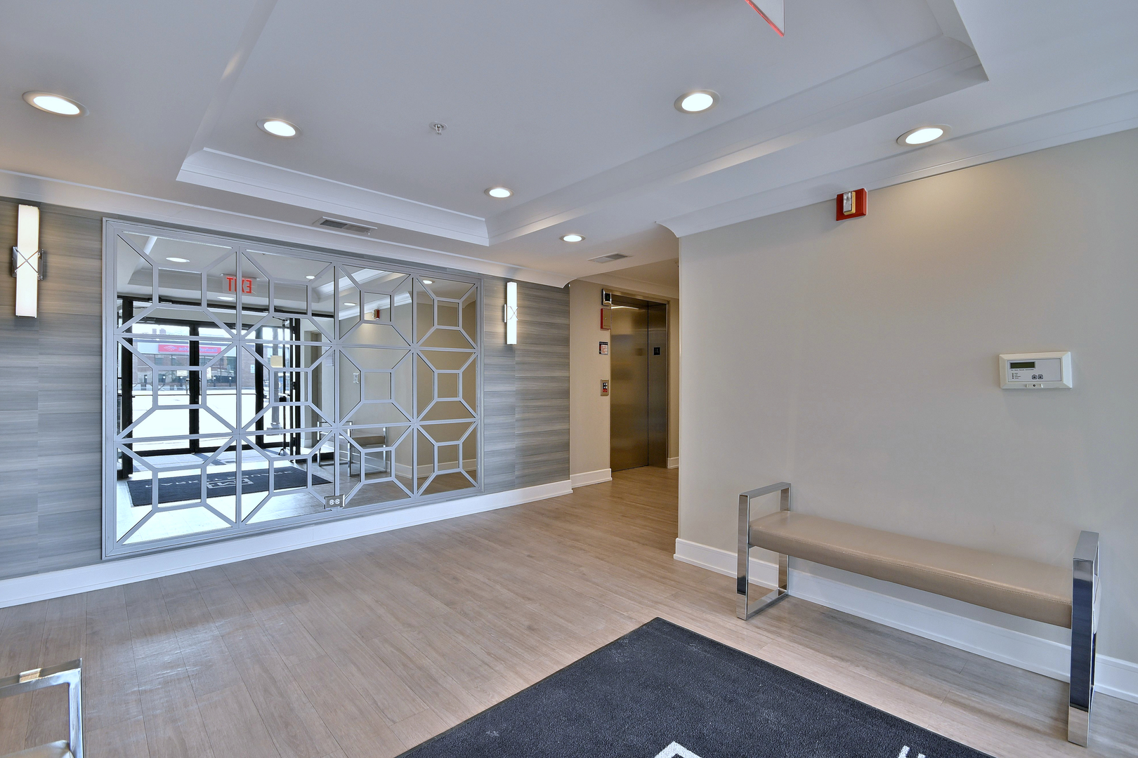 210 North Addison Avenue, Unit 301 Elmhurst, IL 60126 - Photo 6 of 30 a hallway with a large mirror and furniture