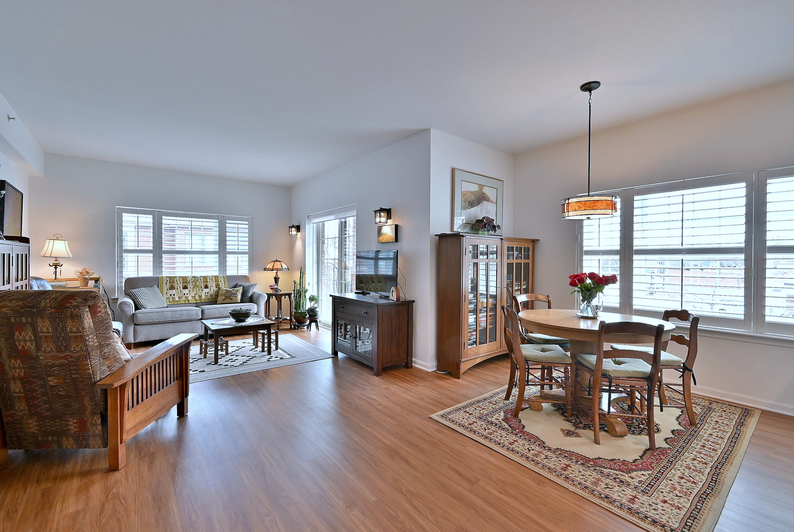 210 North Addison Avenue, Unit 301 Elmhurst, IL 60126 - Photo 10 of 30 a living room with furniture a dining table and a wooden floor