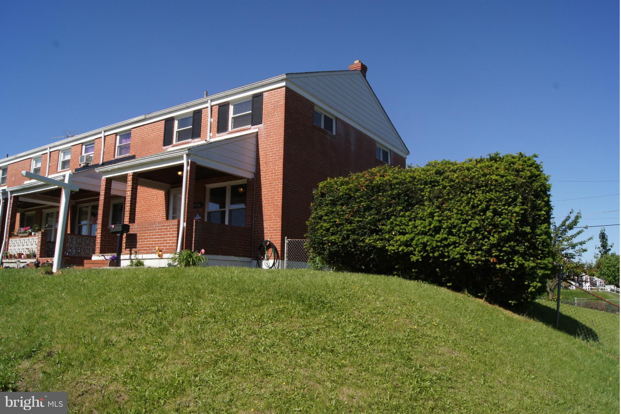 7954 Charlesmont Road Baltimore, MD 21222 - Photo 1 of 24 a front view of a house with a yard