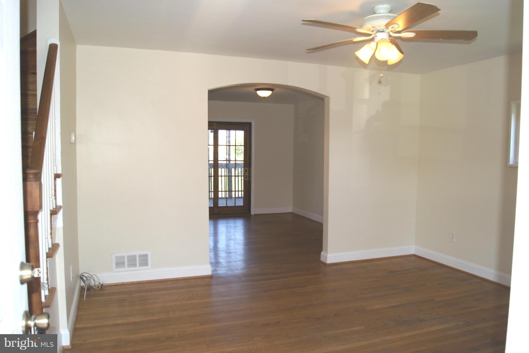 7954 Charlesmont Road Baltimore, MD 21222 - Photo 2 of 24 wooden floor in an empty room with a window