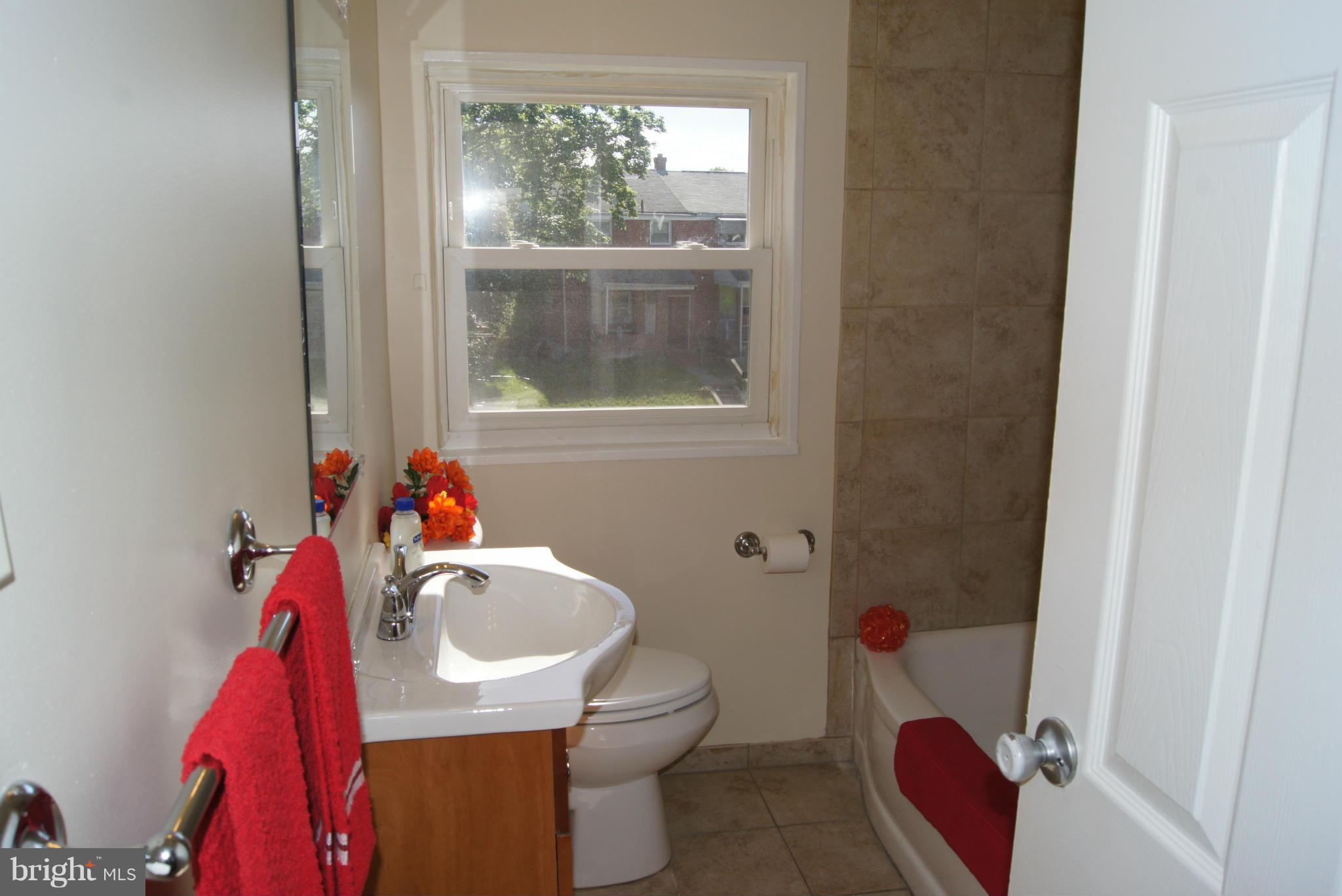 7954 Charlesmont Road Baltimore, MD 21222 - Photo 13 of 24 a bathroom with a sink toilet and a mirror