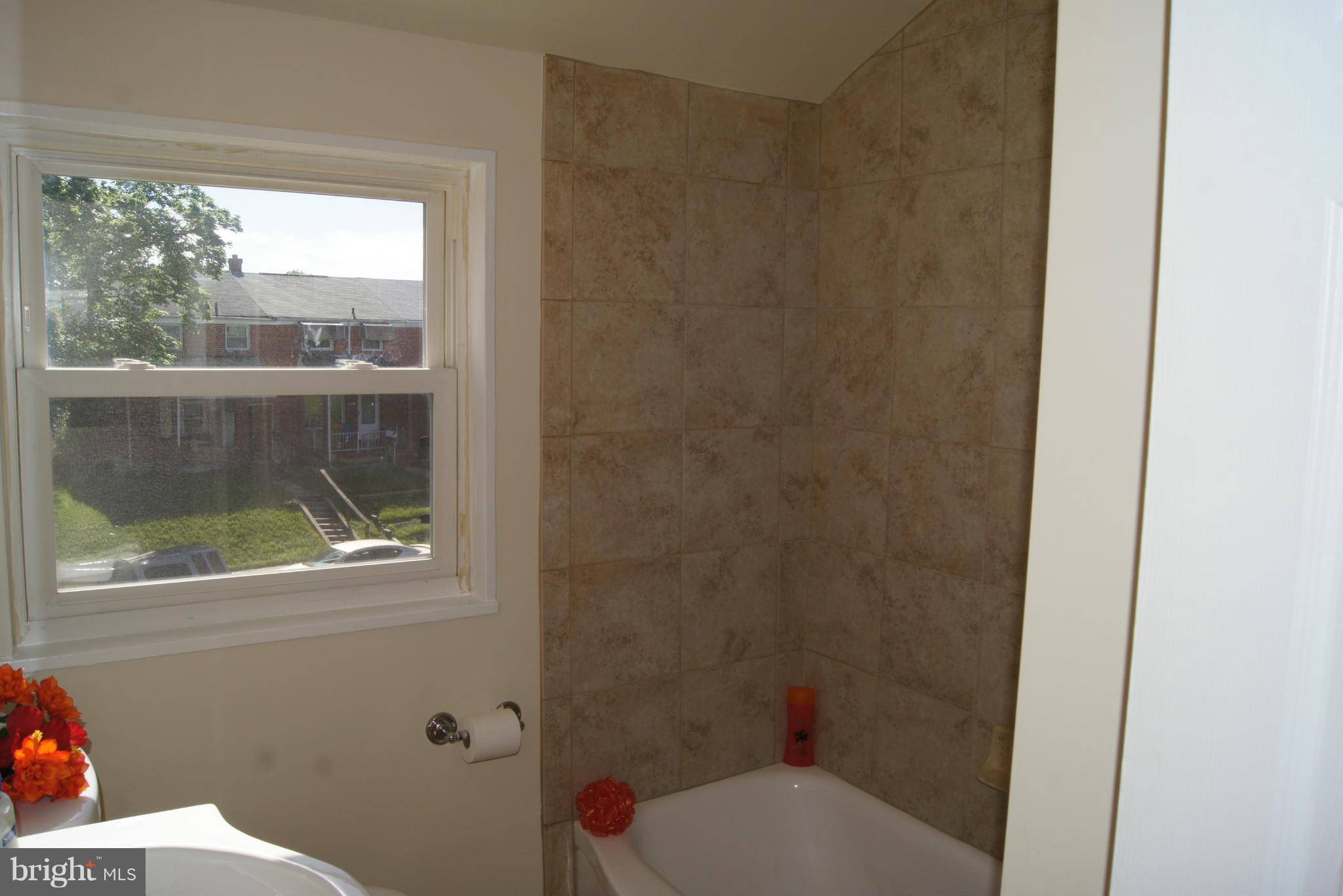 7954 Charlesmont Road Baltimore, MD 21222 - Photo 14 of 24 a bathroom with a toilet and a shower