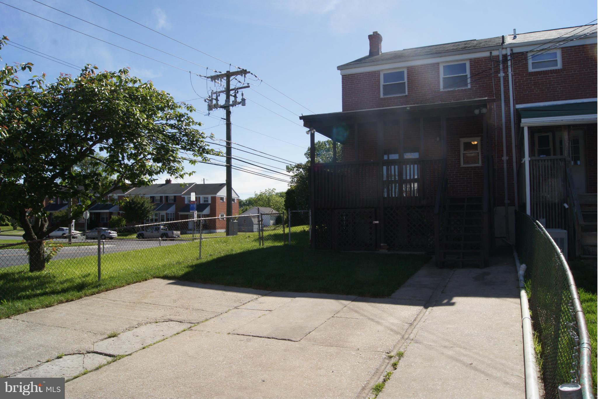 7954 Charlesmont Road Baltimore, MD 21222 - Photo 23 of 24 a front view of a house with a yard