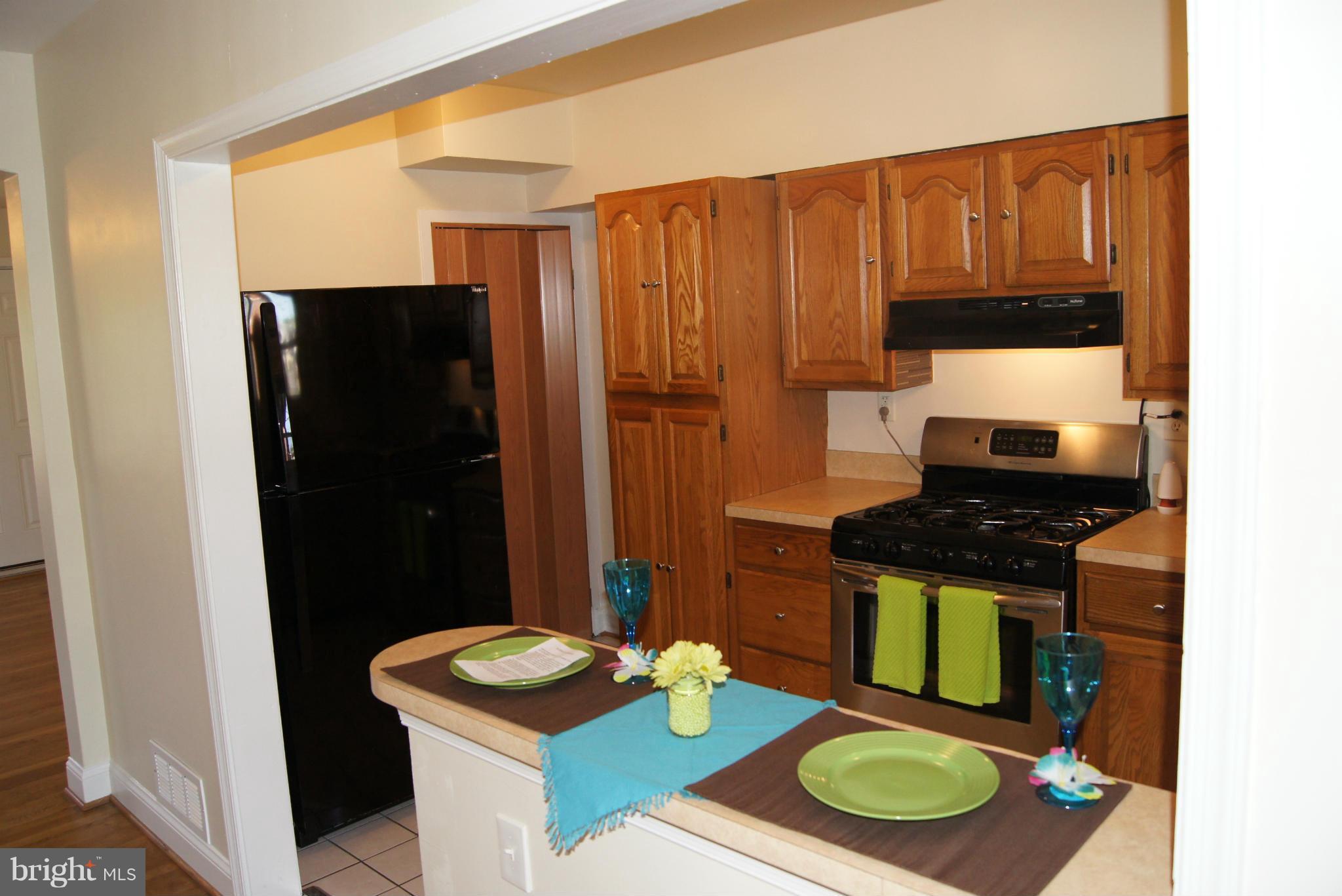 7954 Charlesmont Road Baltimore, MD 21222 - Photo 6 of 24 a kitchen with a sink stove and refrigerator