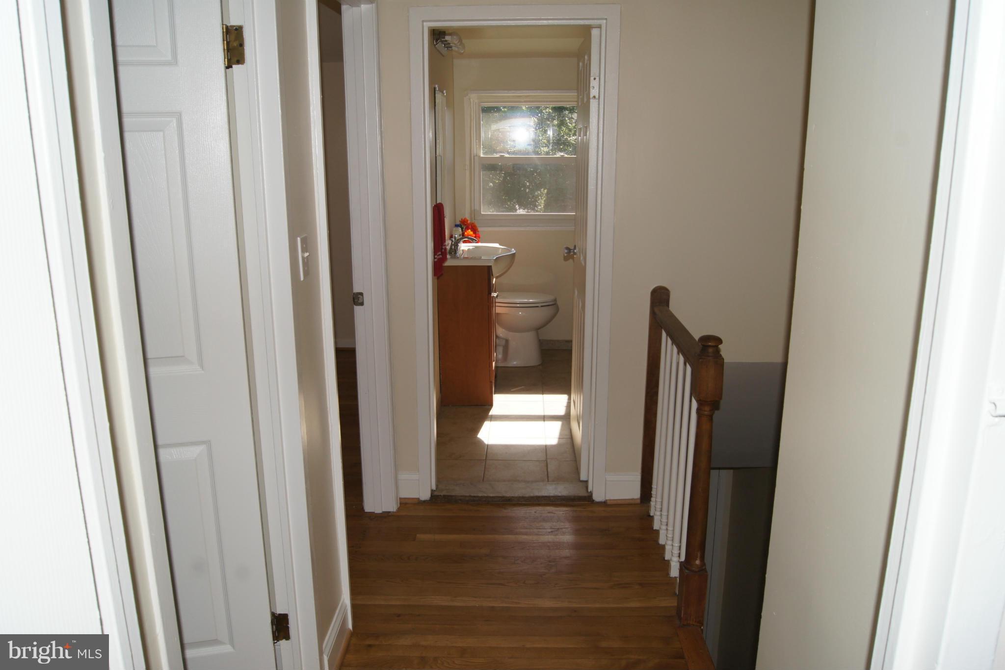 7954 Charlesmont Road Baltimore, MD 21222 - Photo 8 of 24 a view of a hallway with a wooden door