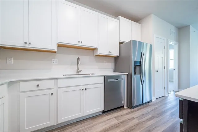 a kitchen with cabinets and stainless steel appliances