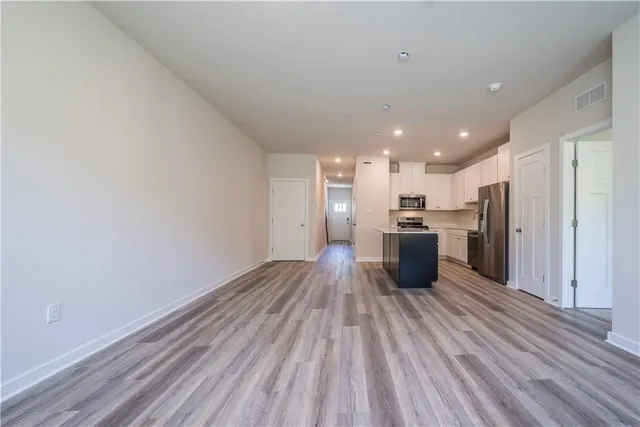 a kitchen with stainless steel appliances a refrigerator and a stove top oven