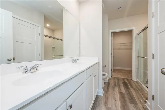 a bathroom with a sink a mirror and a shower