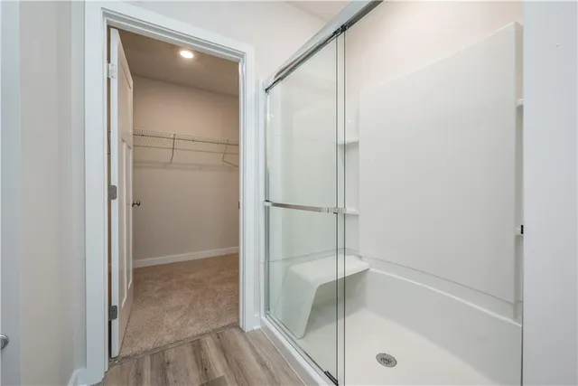 a bathroom with a glass shower door