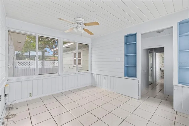 a bath tub sitting next to a white sink and a shower