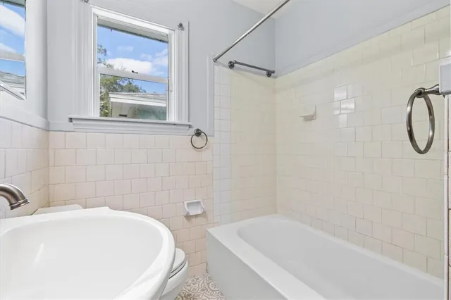 a backyard of a house with large trees and wooden fence