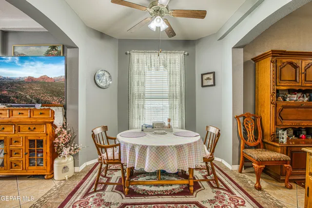 a living room with furniture ceiling fan and a rug