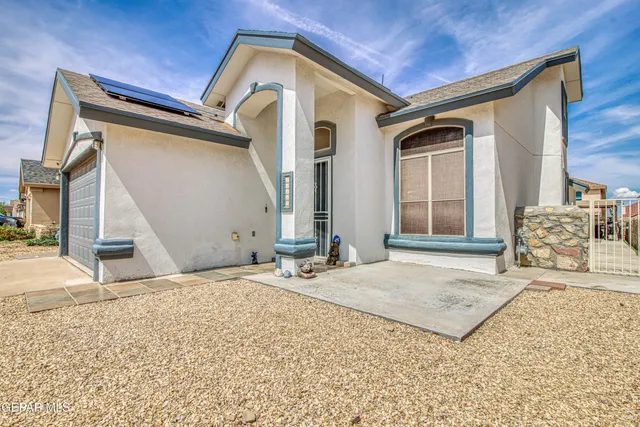 a view of a house with a barbeque and wooden stairs