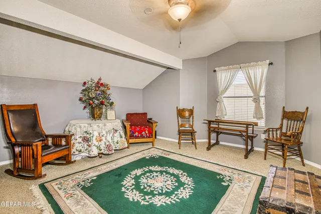 a view of a patio with a table and chairs under an umbrella