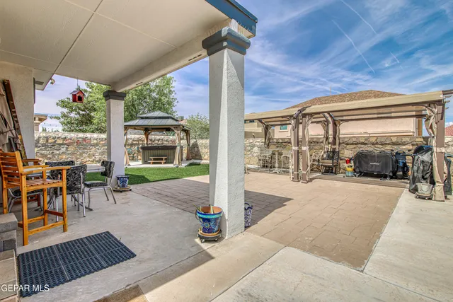 a view of a house with wooden roof and sitting space
