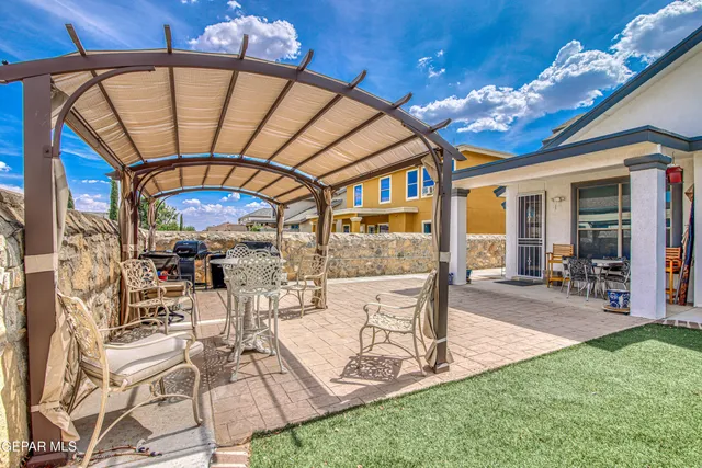 an aerial view of residential houses with outdoor space and seating