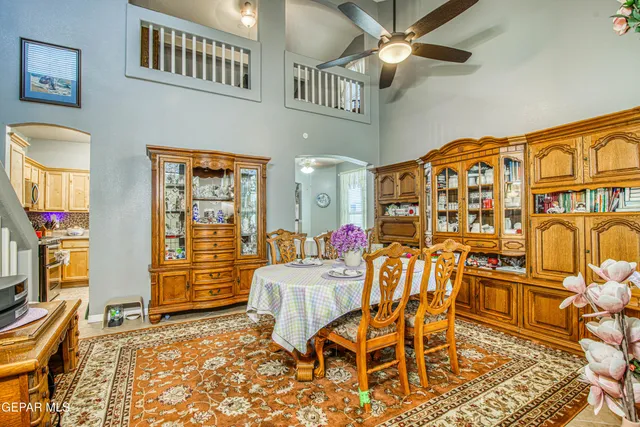 a dining room with furniture a rug and wooden floor