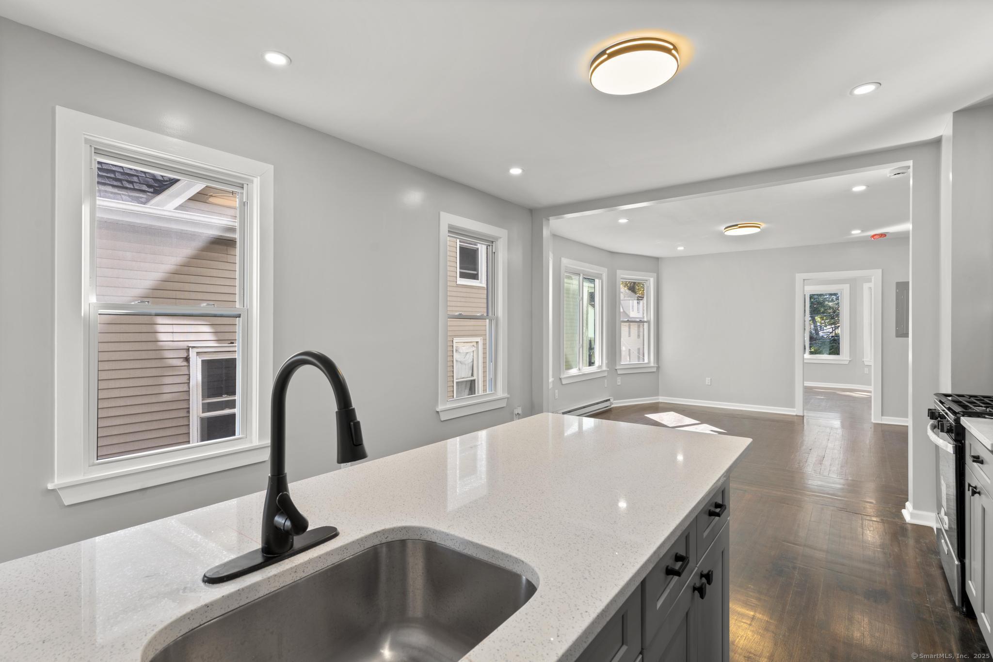 230 Cooke Street, Unit 2 Waterbury, CT 06710 - Photo 15 of 16 a kitchen with a sink appliances and a counter top space
