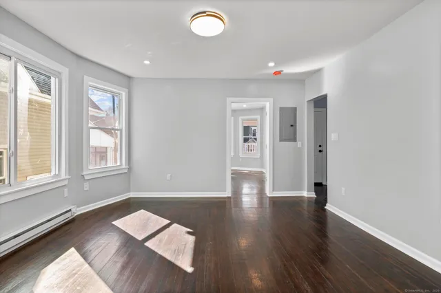wooden floor in an empty room with a window