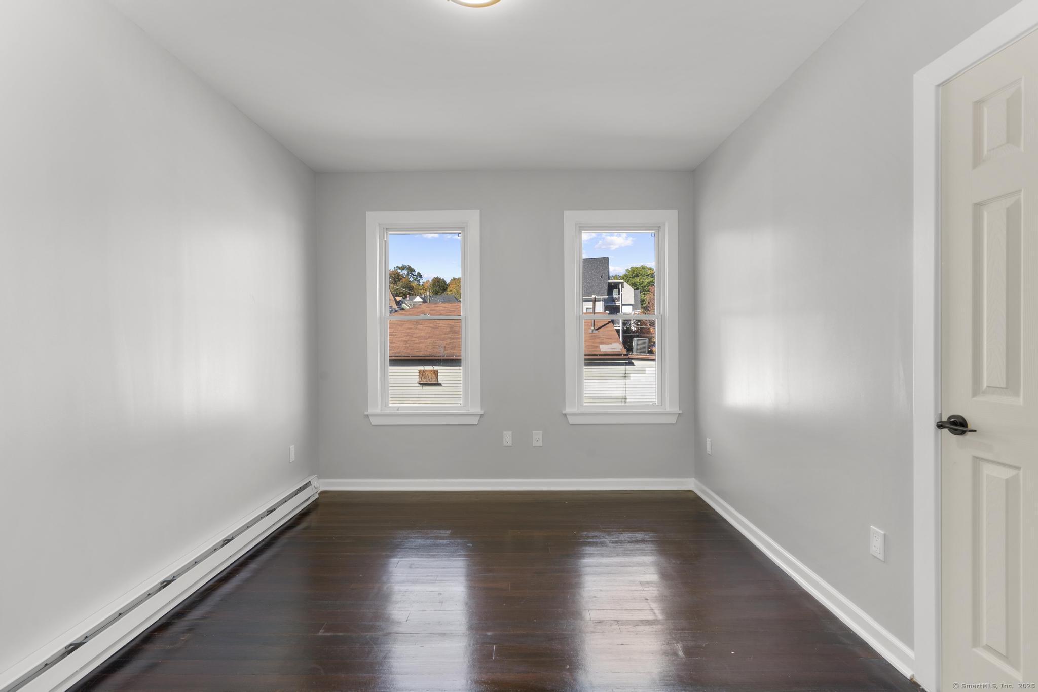 230 Cooke Street, Unit 2 Waterbury, CT 06710 - Photo 7 of 16 wooden floor in an empty room with a window