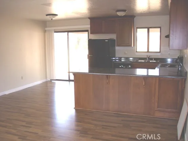 a view of a kitchen with wooden floor and a large window