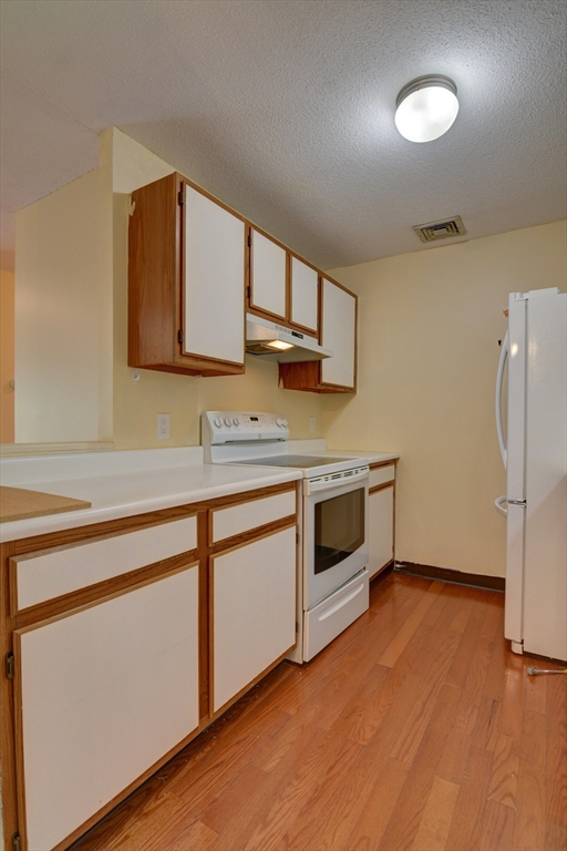 15 Bower Road, Unit A11 Quincy, MA 02169 - Photo 12 of 29 a kitchen with stainless steel appliances a stove a sink and a microwave