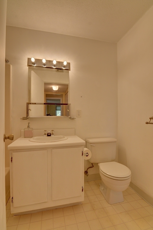 15 Bower Road, Unit A11 Quincy, MA 02169 - Photo 21 of 29 a bathroom with a sink a toilet and mirror