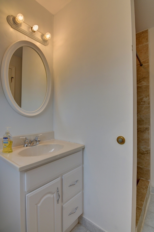 15 Bower Road, Unit A11 Quincy, MA 02169 - Photo 24 of 29 a bathroom with a sink and a mirror