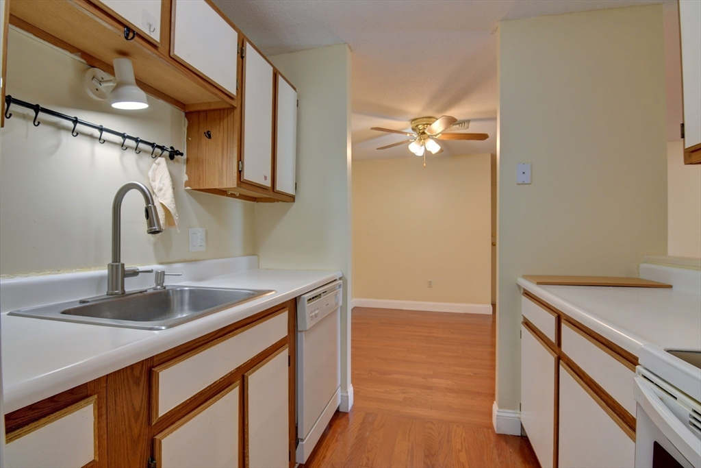 15 Bower Road, Unit A11 Quincy, MA 02169 - Photo 8 of 29 a kitchen with a sink cabinets and a stove
