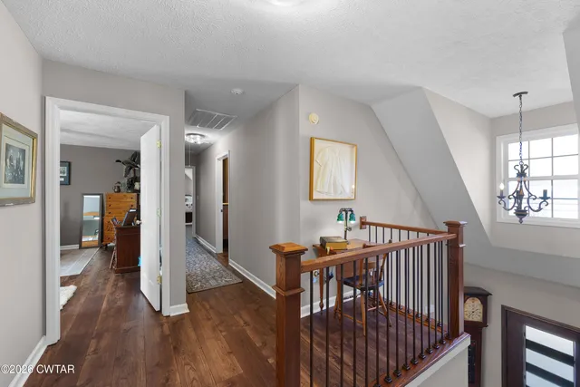 a hallway with furniture and wooden floor