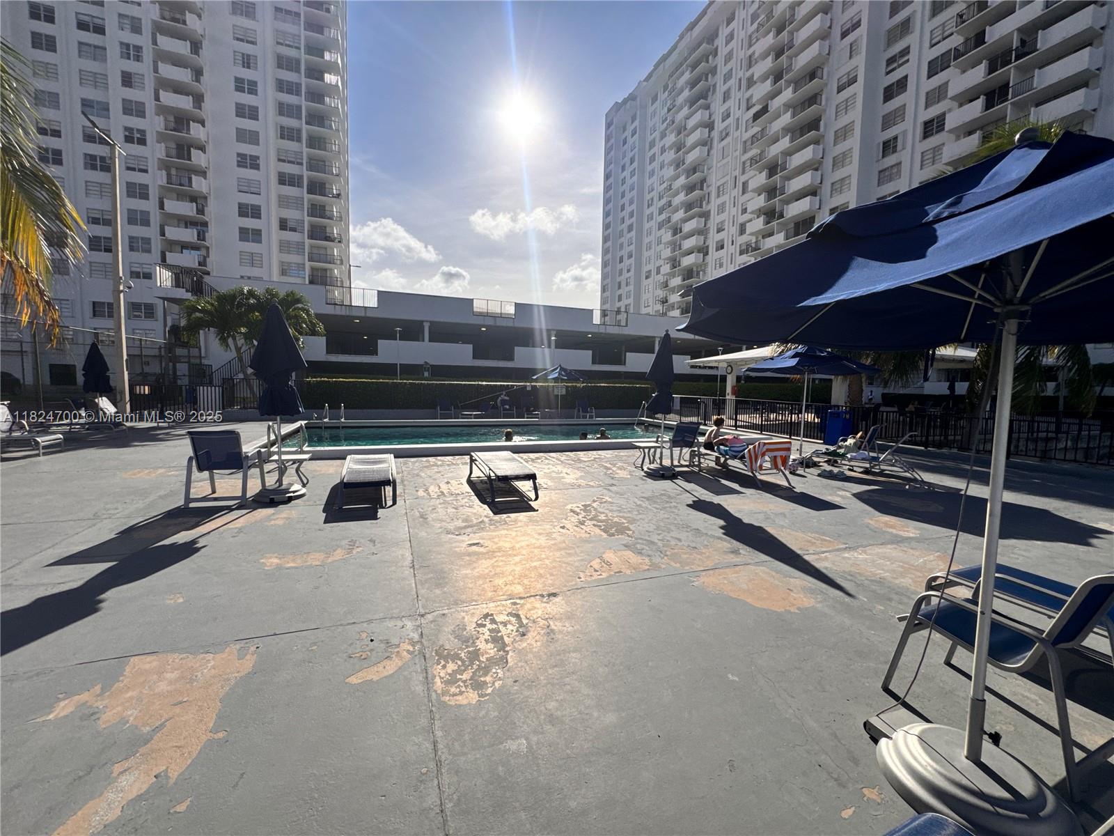 2750 Northeast 183rd Street, Unit 2103 Aventura, FL 33160 - Photo 13 of 30 a building with table and chairs
