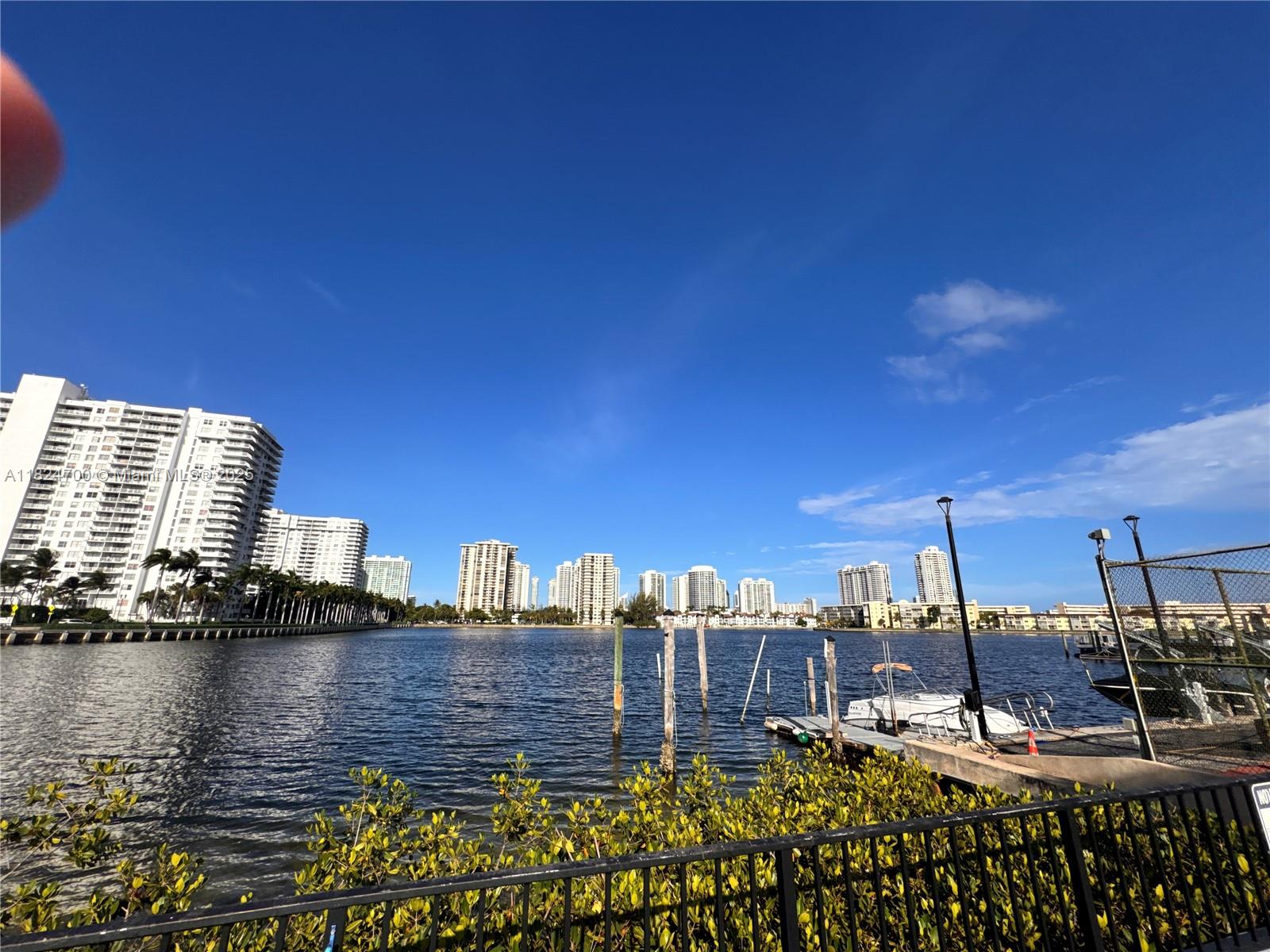 2750 Northeast 183rd Street, Unit 2103 Aventura, FL 33160 - Photo 15 of 30 a view of a lake with a building in the background
