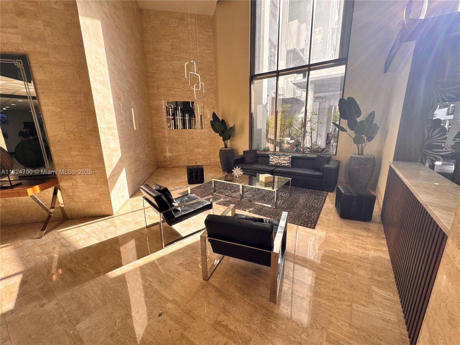 2750 Northeast 183rd Street, Unit 2103 Aventura, FL 33160 - Photo 17 of 30 a living room with furniture a large window and a flat screen tv