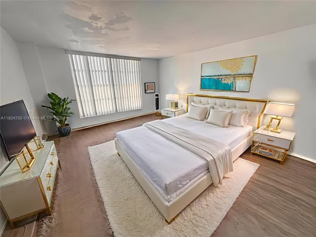 a bathroom with a sink a mirror a toilet and shower