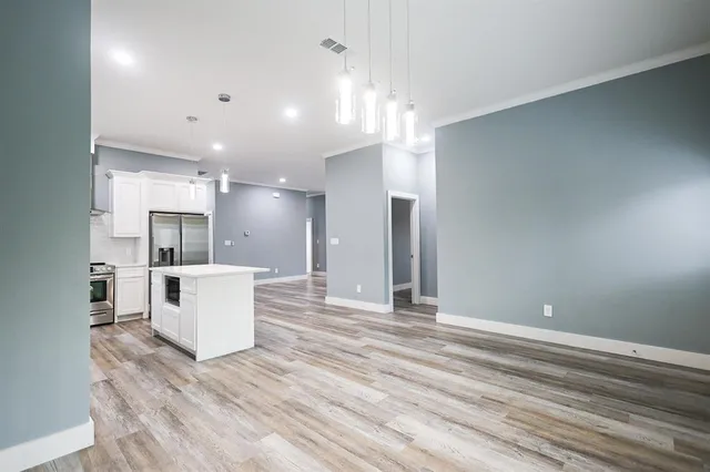 a view of kitchen with sink and refrigerator