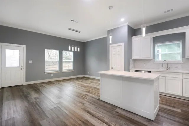 a view of kitchen with sink and wooden floor