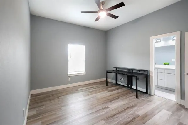 a living room with wooden floor and a window