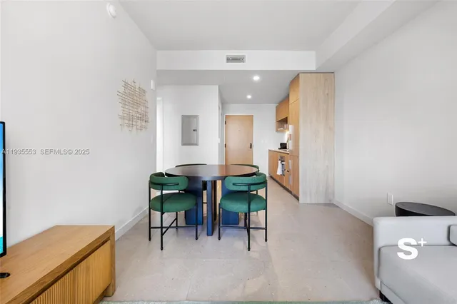 a living room with furniture and a dining table