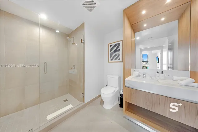 a spacious bathroom with a sink a toilet and shower