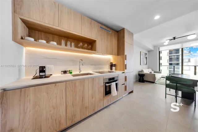 a kitchen with stainless steel appliances a sink and cabinets