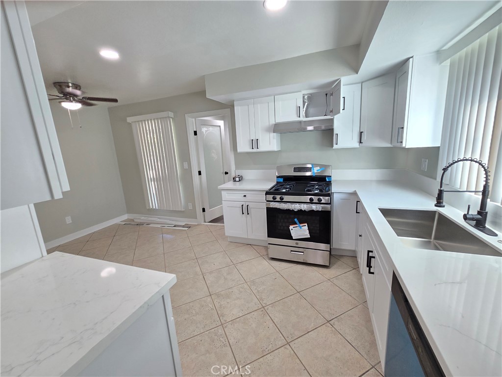 775 Libby Drive Riverside, CA 92507 - Photo 12 of 28 a kitchen with a sink a stove and cabinets