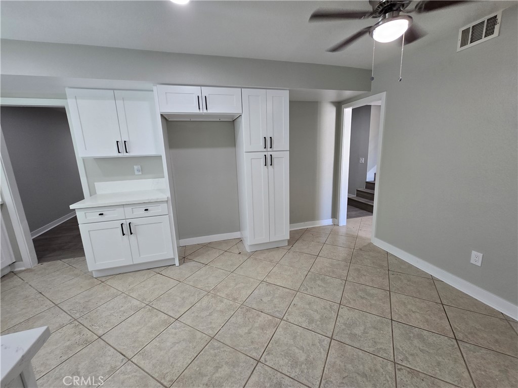 775 Libby Drive Riverside, CA 92507 - Photo 14 of 28 a kitchen with granite countertop white cabinets and refrigerator